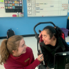a researcher in the classroom with a graduate student with complex communication needs