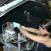 Woman wearing gloves works on scientific equipment
