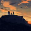 silhouette of a family on a mountaintop 