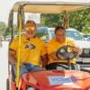 Chancellor Justin Schwartz and Vice Chancellor D'Andra Mull drive a golf cart during move-in