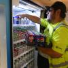 Pepsi employee loading drinks into a vending machine