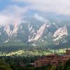 campus buildings with the Flatirons in the background during summer