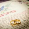 two gold wedding rings on a Jewish marriage certificate