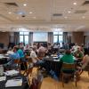 Faculty sit at tables during a session at the New Leaders Orientation