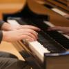 person playing grand piano