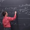 instructor writing on blackboard
