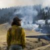 A firefighter watches as the NCAR Fire burns on March 26, 2022