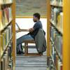 student studying in a library on campus