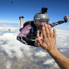 Adam Harris gives a high five while sky diving