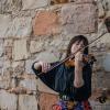 Enion Pelta-Tiller playing violin outside