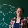 Katherine Stange in front of a chalkboard