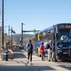 people boarding a Flatiron Flyer bus