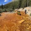 Athena Bolin collects a water sample near Aspen