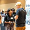 student speaking with an employer at an on-campus job fair