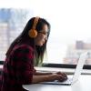 person wearing headphones at computer