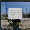 Student takes a photo of a handwritten business sign