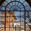 Old Main building reflected in a window with panes