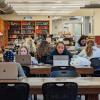 students studying in a library on campus