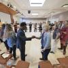 People stand in a circle and shake hands during a summit session
