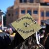 Graduation cap decorated to say "Nevertheless she persisted"