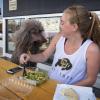 Student Clare Bradley enjoys a lunch outside with her standard poodle Delilah