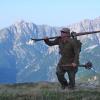 Chris Anthony carries a pair of World War II-era skis up the flanks of Mount Mangart