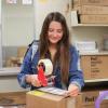 Student-worker packages books from the library