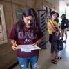 Student looks at orientation paper during Fall Welcome