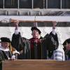Bud Coleman lifts the ceremonial mace as part of commencement