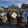 students sit on Folsom Field during 2018 commencement ceremony