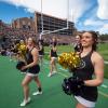 Cheerleaders on the sidelines of a Homecoming football game