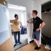 Student chats with RA outside of dorm room