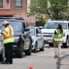 Volunteers keep the traffic moving. Volunteers, students and parents work together to move students back onto the CU Boulder campus on Sunday, August 19, 2018. (Photo by Glenn Asakawa/University of Colorado)