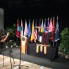 A camera records Bud Coleman as he lowers the ceremonial mace