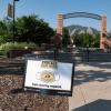 A Protect Our Herd–face covering required sign at the entrance of Farrand Field