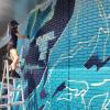 Artist Kendall Rose Kippley paints a mural in Boulder showing Arctic sea ice loss over time, based on NSIDC data. (Photo by Seamus McAfee, NSIDC)