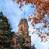Old Main building framed by fall leaves