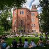 Students sit in a circle in the grass