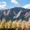 View of the Flatirons from CU Boulder campus in spring.