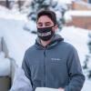 student outside on campus wearing CU mask