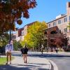 Campus community members walking on campus with fall foliage
