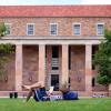 Charles Lipscomb, Grad student in Aerospace Engineering, reads a book while enjoying the nice weather. Photo by Patrick Campbell/University of Colorado