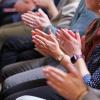 People clapping during a presentation