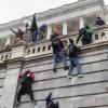 People scaling the outside walls of the U.S. Capitol during the Jan. 6 protests and insurrection in Washington, D.C.