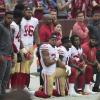 Football players kneeling on the sidelines