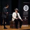 Actors performing on stage with a Colorado Shakespeare Festival banner in the background