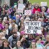 group of people marching to protest abortion ban