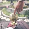 Person spinning globe