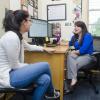 Academic advisor sits across desk from student