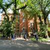 People bike and walk past Old Main